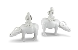 A pair of Chinese 'blanc-de-chine' water buffaloes, Qing Dynasty, late 19th/early 20th century