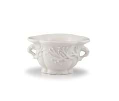 A Chinese 'blanc de chine' rhinoceros horn-form libation cup, Qing Dynasty, 18th century