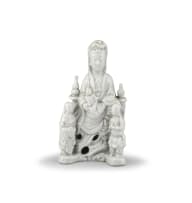 A Chinese 'blanc de chine' figure of seated Guanyin flanked by Bodhisattva, Ming Dynasty, late 16th/early 17th century