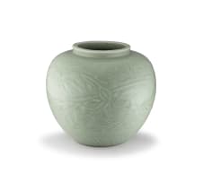 A carved 'Longquan' celadon-glazed floral jar, Ming Dynasty