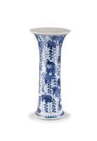 A Chinese blue and white 'squirrel and grape' beaker vase, Qing Dynasty, early Kangxi period (1662-1722)