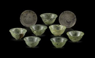 A set of seven Chinese carved mottled jade bowls, Qing Dynasty, 19th century