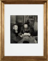 Roman Vishniac; Rabbi Leibel Eisenberg (Reading) and His Shammes. Lask, 1936