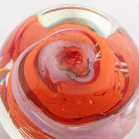 David Reade clear glass paperweight blown with white, red, pink and orange flowers