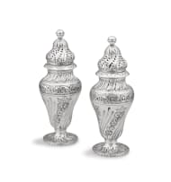 A near pair of Victorian silver sugar casters, Charles Edwards, London, 1884 and 1886