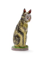 Hylton Nel; A yellow and black cat perched on a round base