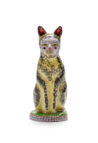 Hylton Nel; A yellow and black cat perched on a round base