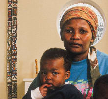 David Goldblatt; Victoria Cobokana, housekeeper, in her employers dining room with her son Sifiso and daughter Onica, Johannesburg, June 1999. Victoria died on AIDS on 13 December 1999, Sifiso died of AIDS on 12 January 2000, Onica died of AIDS in May 2000