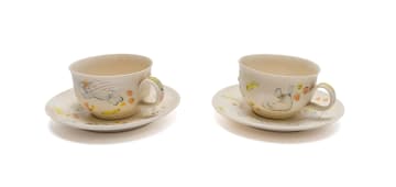 Katherine Glenday; Set of two cups and saucers with angel and banana motifs, two