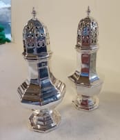 A near pair of Edward VII and George V silver sugar casters, Walker & Hall, Sheffield, 1905 and 1930