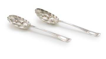 A pair of berry spoons and sugar tongs, makers and date marks indistinct, London