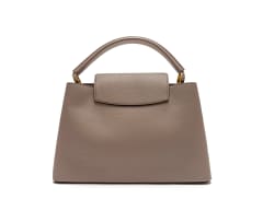 Louis Vuitton; A Galet Gray Louis Vuitton Taurillon Leather Capucines MM Bag with Gold Tone Hardware