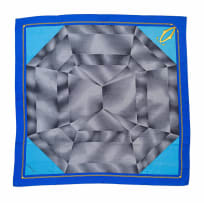 Cartier; A Vintage Must de Cartier Silk Scarf with Grey and Charcoal Geometric Patterns Forming a Diamond on a Blue Ground with Stylised Rope Trim