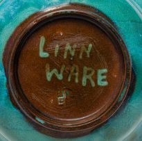 Linn Ware; Bulbous bowl with flared neck and floral frog, two