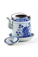 A Chinese teapot, late 19th century and a blue and white dish, 18th century, depicting Guanyin in the hall of the hundred children