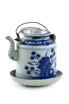 A Chinese teapot, late 19th century and a blue and white dish, 18th century, depicting Guanyin in the hall of the hundred children