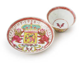A Chinese famille rose porcelain cup and saucer bearing the arms of the Dutch East India Company, Yongzheng period, dated 1728
