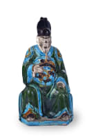 A Chinese Fehua-glazed earthenware figure of a seated official, late Ming Dynasty, 1368-1644