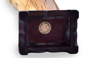 A Chinese ivory tusk carving depicting the Daoist Immortal Zhongli Quan on wooden base, 17th century