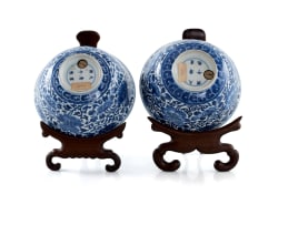 A pair of Chinese blue and white porcelain rice bowls on rosewood stands, Kangxi period, 1662-1722