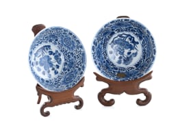 A pair of Chinese blue and white porcelain rice bowls on rosewood stands, Kangxi period, 1662-1722