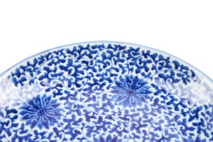 A Chinese blue and white porcelain plate, decorated with floral roundels and scrolling foliage