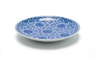 A Chinese blue and white porcelain plate, decorated with floral roundels and scrolling foliage