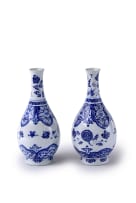 A pair of Chinese blue and white porcelain slender-necked bottles, Kangxi period, 1662-1722