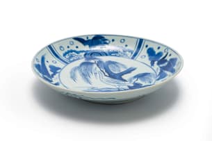 A Chinese blue and white porcelain plate, decorated with cranes in a landscape setting