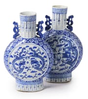A pair of Chinese blue and white porcelain moon flasks, decorated with dragons and cloud scrolls, 19th century