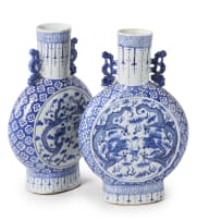 A pair of Chinese blue and white porcelain moon flasks, decorated with dragons and cloud scrolls, 19th century