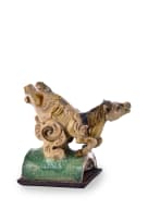 A Chinese ceramic ridge tile modelled as a galloping horse on wooden base, Ming dynasty, 1368–1644