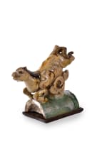 A Chinese ceramic ridge tile modelled as a galloping horse on wooden base, Ming dynasty, 1368–1644