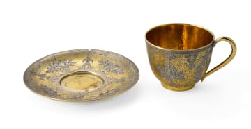 A Russian silver gilt enamel cup and saucer, maker's mark 'A.T', c.1850