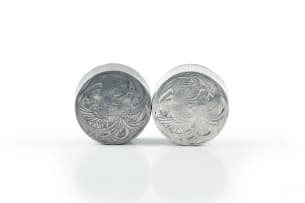 René Lalique; Two René Lalique 'Fleurs d'Amour' aluminium powder compacts for Roger et Gallet, designed 1922