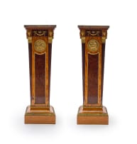 A pair of Empire style mahogany, birds-eye-maple and satinwood-veneered gilt-brass mounted pedestals, late 19th/early 20th century