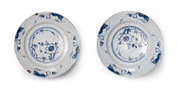 A pair of Delft bowls with flower and foliage motif, circa 18th century.
