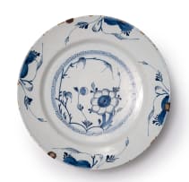 A pair of Delft bowls with flower and foliage motif, circa 18th century.