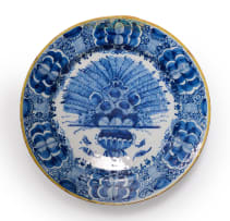 A Dutch Delft blue and white peacock patterned platter with yellow rim