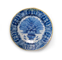 A Dutch Delft blue and white peacock patterned platter with yellow rim