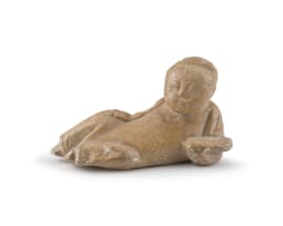 A Chinese lacquer mirror and a carved soapstone figure of a recumbent boy, Ming Dynasty, early 18th century