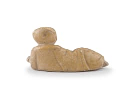 A Chinese lacquer mirror and a carved soapstone figure of a recumbent boy, Ming Dynasty, early 18th century