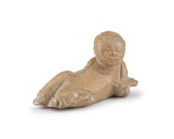 A Chinese lacquer mirror and a carved soapstone figure of a recumbent boy, Ming Dynasty, early 18th century