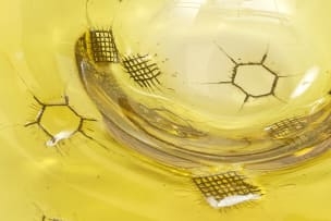 Adam Jablonski; An amber lead crystal bowl with embedded metal mesh