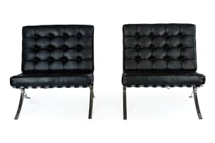 Ludwig Mies van der Rohe; Pair of black leather and chrome 'Barcelona' chairs, after a design in 1929 by Ludwig Mies van der Rohe, Italy