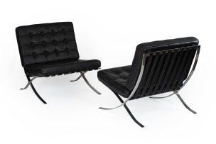 Ludwig Mies van der Rohe; Pair of black leather and chrome 'Barcelona' chairs, after a design in 1929 by Ludwig Mies van der Rohe, Italy