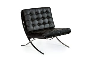 Ludwig Mies van der Rohe; Pair of black leather and chrome 'Barcelona' chairs, after a design in 1929 by Ludwig Mies van der Rohe, Italy