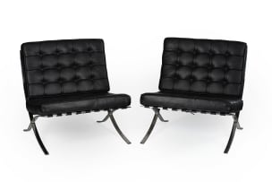 Ludwig Mies van der Rohe; Pair of black leather and chrome 'Barcelona' chairs, after a design in 1929 by Ludwig Mies van der Rohe, Italy