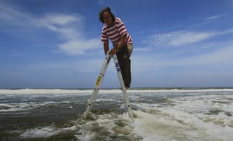 Jacques Coetzer; One Meter above Mean Sea Level, Artist Jacques Coetzer Suspended over the Warm Waters of Durban, South Africa, December 2, 2011